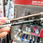 A Person Holding Two Rimmel Scandaleyes Waterproof Eyeliner Pencils