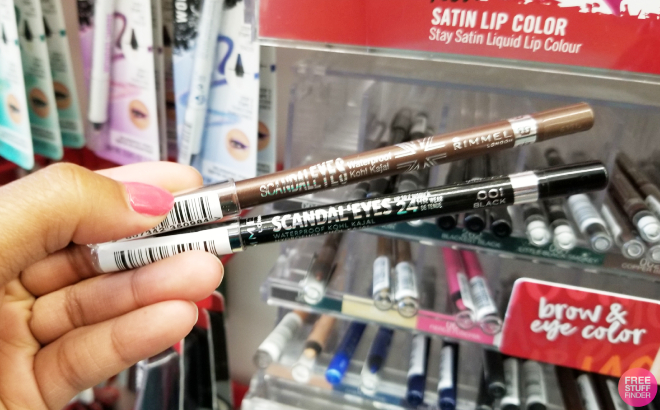 A Person Holding Two Rimmel Scandaleyes Waterproof Eyeliner Pencils