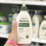 A Person Holding a Bottle of Aveeno Daily Moisturizer Body Lotion