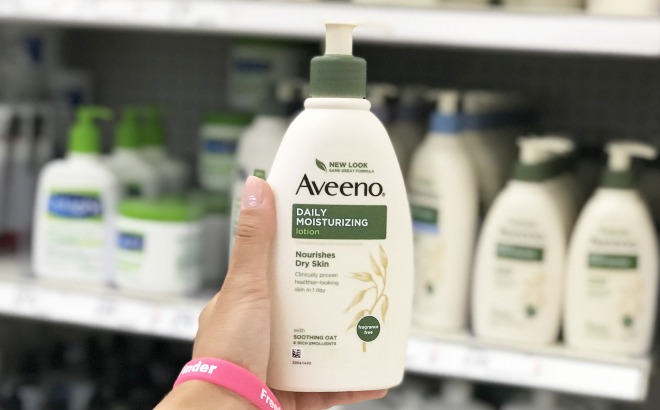 A Person Holding a Bottle of Aveeno Daily Moisturizer Body Lotion