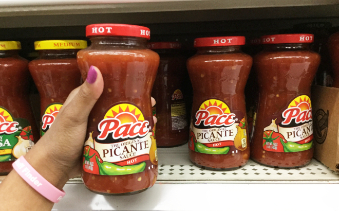 A Person Holding a Bottle of Pace Hot Picante Sauce