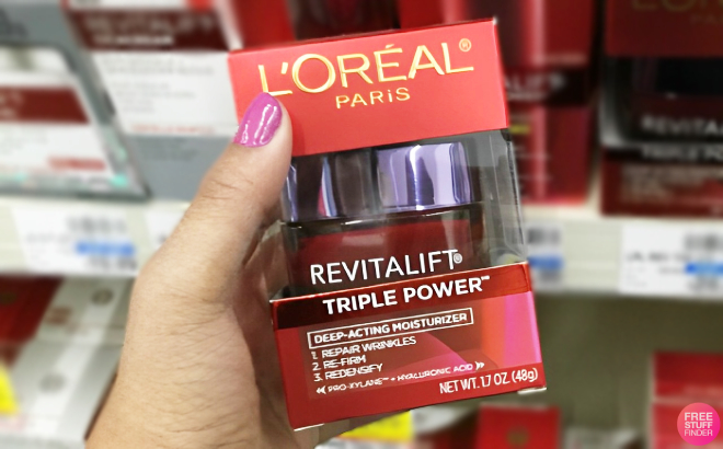 A Person Holding a LOreal Triple Power Anti Aging Moisturizer