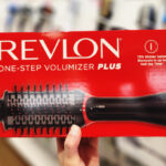 A Person Holding a Revlon One Step Volumizer Plus