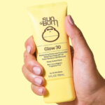 A Person Holding a Sun Bum Original SPF 30 Glow Sunscreen