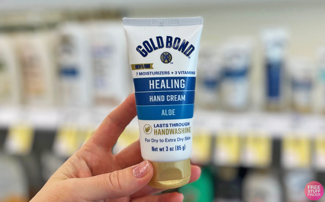 A Person Holding a Tube of Gold Bond Healing Hand Cream