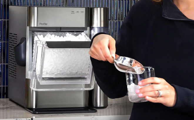 A Person Putting Ice in a Glass