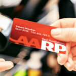 A Person Using Aarp Membership Card for Savings