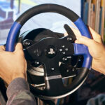 A Person Using Thrustmaster Racing Wheel for Gaming