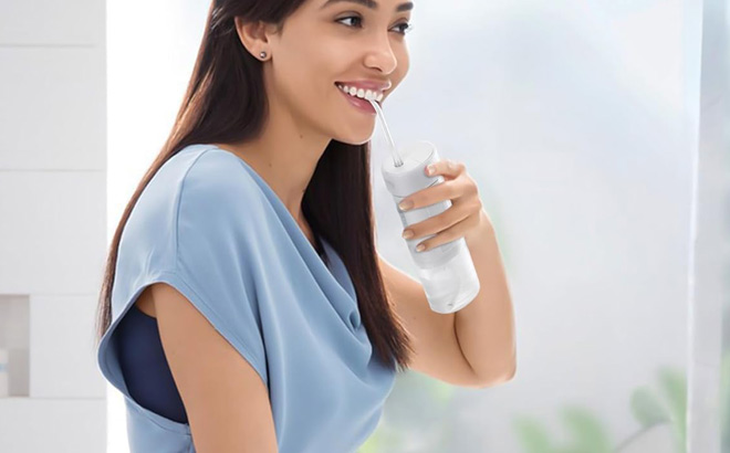 A Person Using Water Flosser