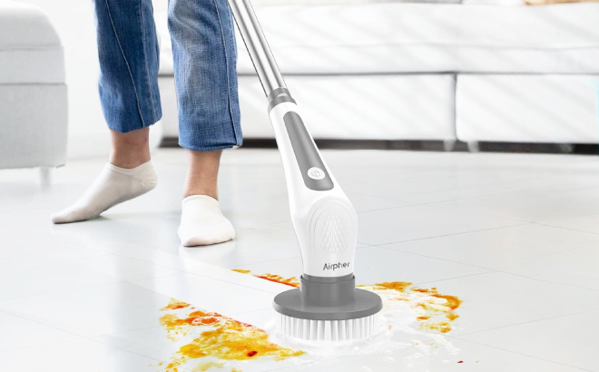 A Person Using an Electric Spin Scrubber to clean the floor 1