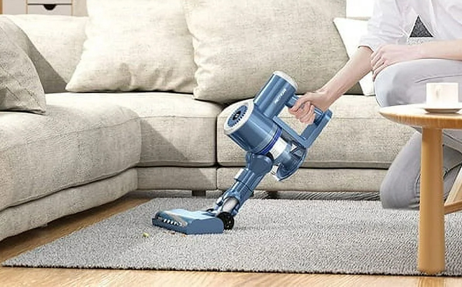 A Person Using the Prettycare Cordless Stick Vacuum Cleaner