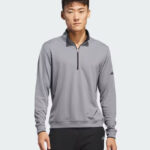 A Person Wearing Adidas Mens Lightweight Half Zip Top in Grey Color