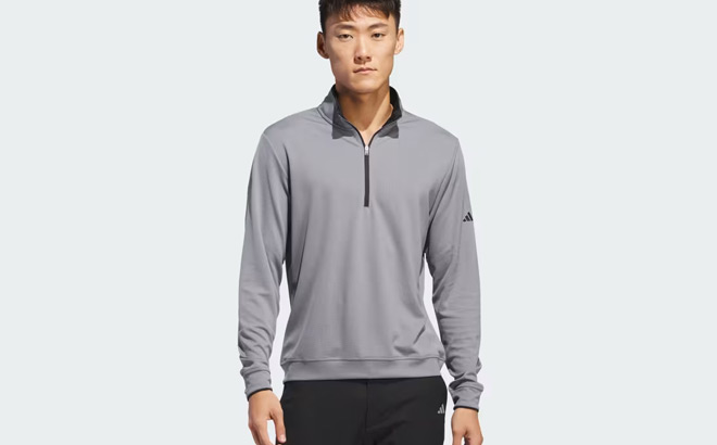 A Person Wearing Adidas Mens Lightweight Half Zip Top in Grey Color