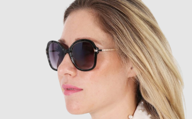 A Person Wearing Guess Womens Black Sunglasses