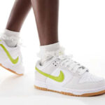 A Person Wearing Nike Dunk Low Shoes in White Gum Yellow Bright Cactus Color