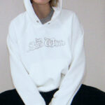 A Person Wearing the HM Oversized Hoodie in White with Motif