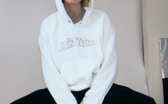 A Person Wearing the HM Oversized Hoodie in White with Motif