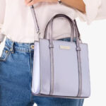 A Person Wearing the Kate Spade Kenzie Small Tote in Light Blue