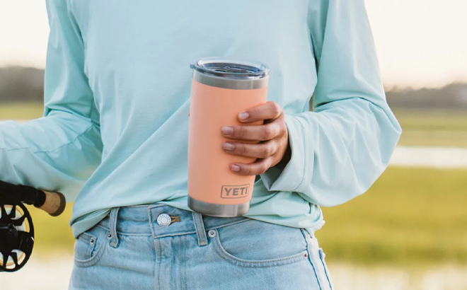 A Person holding a Yeti 20 Ounce Rambler Tumbler