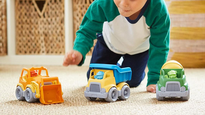 A Person playing with Green Toys Construction Vehicle 3 Pack