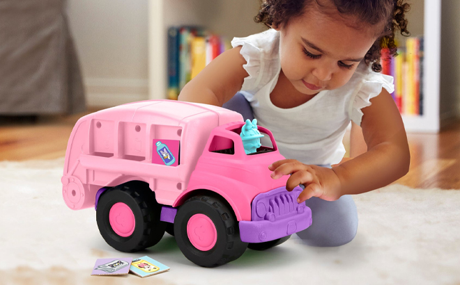 A Person playing with Green Toys Disney Baby Exclusive Minnie Mouse Recycling Truck