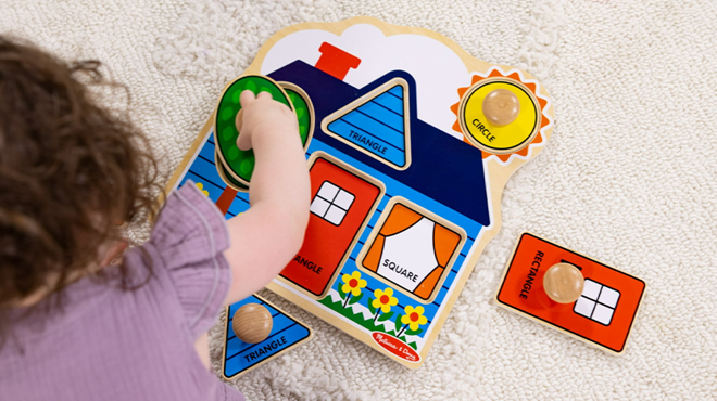 A Person playing with Melissa Doug First Shapes Jumbo Knob Wooden Puzzle