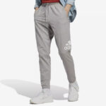 A Person wearing Adidas Mens Essentials Jersey Tapered Pants