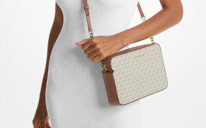 A Person wearing Michael Kors Large Printed Logo Crossbody Bag