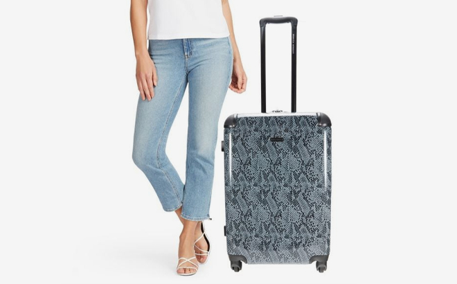 A Rebecca Minkoff Luggage Suitcase Next to a Person