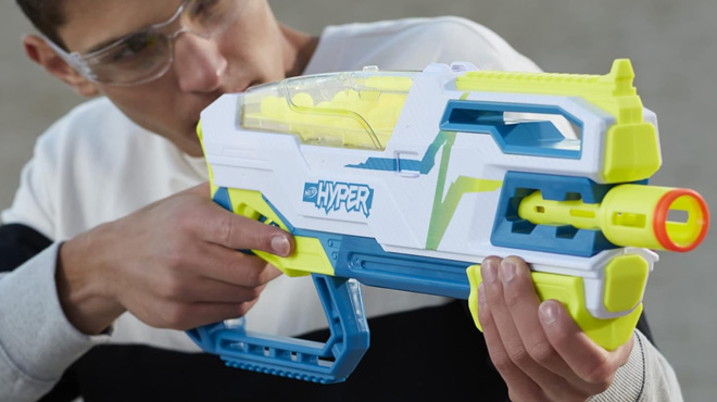 A Teenage Boy Playing with the NERF Siege 50 Pump Action Blaster Bundle