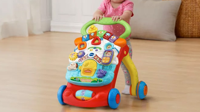 A Toddler Girl Playing with the VTech Stroll and Discover Activity Walker