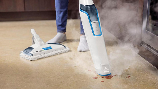 A Woman Cleaning a Floor Stain with Bissell PowerFresh Deluxe Pet Scrubbing Steam Mop with SpotBoost Brush