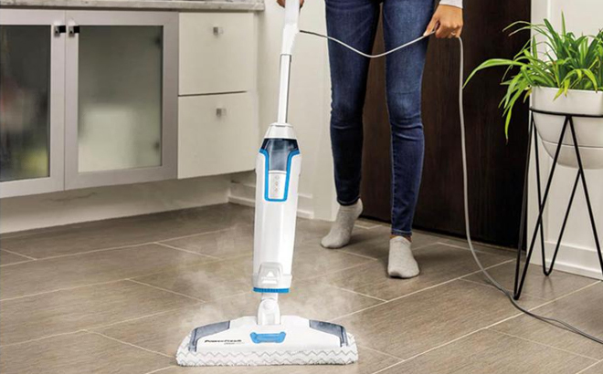 A Woman Cleaning the Floors with Bissell PowerFresh Deluxe Pet Scrubbing Steam Mop with SpotBoost Brush