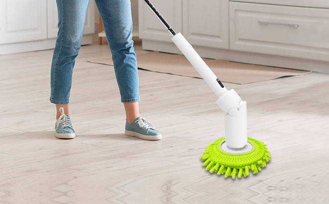 A Woman Cleaning the Kitchen Floors with an Electric Spin Scrubber