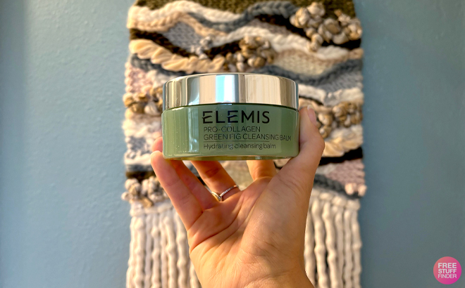 A Woman Holding Elemis Pro Collagen Green Fig Cleansing Balm