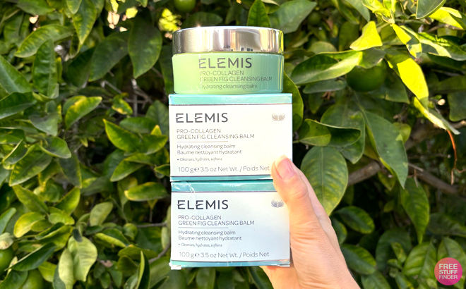 A Woman Holding Elemis Pro Collagen Green Fig Cleansing Balms