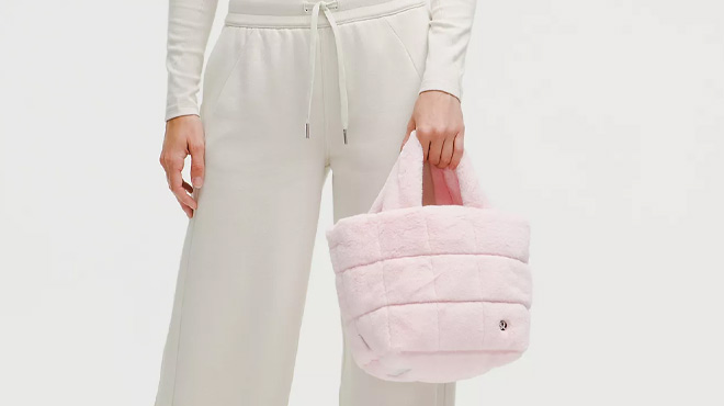 A Woman Holding Lululemon Quilted Grid Plush Fleece Mini Tote Bag