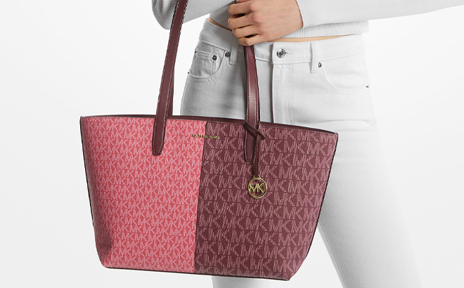 A Woman Holding Michael Kors Jet Set Medium Two Tone Logo Tote Bag