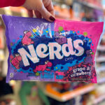 A Woman Holding Nerds Candy Bag in Strawberry & Grape