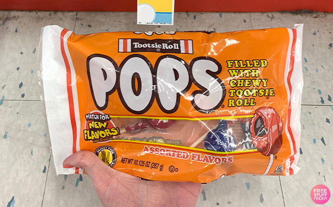 A Woman Holding Tootsie Roll Pops Assorted Flavor Lollipops