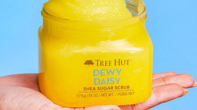 A Woman Holding Tree Hut Dewy Daisy Shea Sugar Scrub