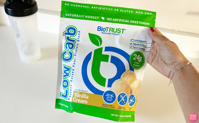 A Woman Holding a Bag of BioTrust Low Carb Protein