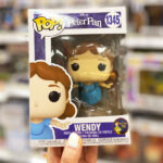 A Woman Holding a Funko Pop Disney Wendy Figure