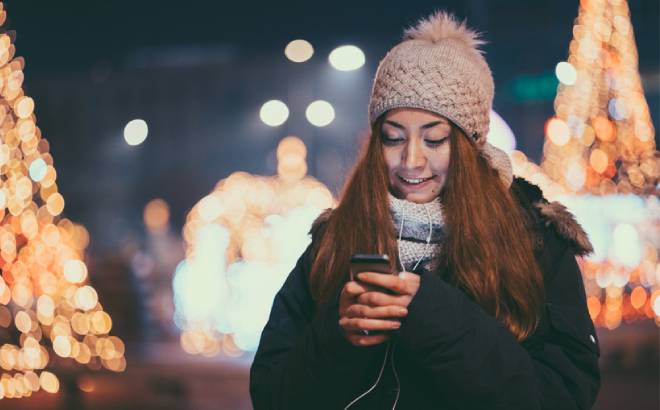 A Woman in a Holiday Setting Using her Smartphone