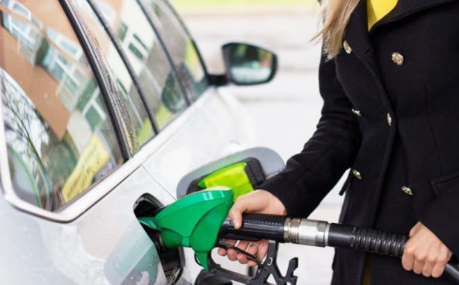 A Woman Refueling the Gas Tank at the Gas Station