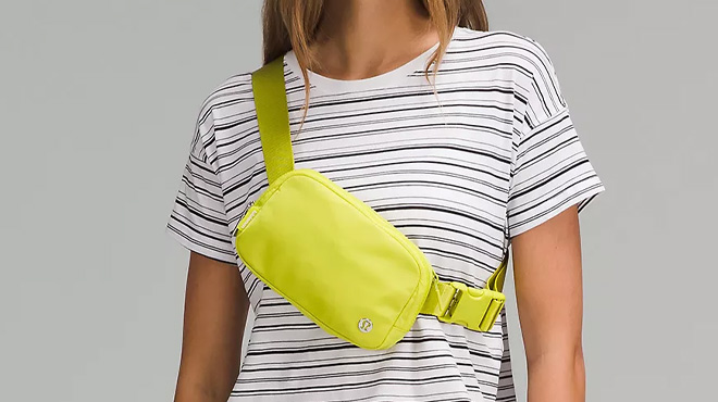 A Woman Wearing Lululemon Everywhere Belt Bag in Yellow Serpentine