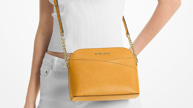 A Woman Wearing Michael Kors Jet Set Travel Medium Dome Crossbody Bag