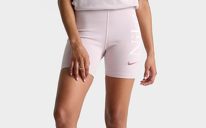 A Woman Wearing Nike Sportswear Classic High Waisted Graphic Biker Shorts