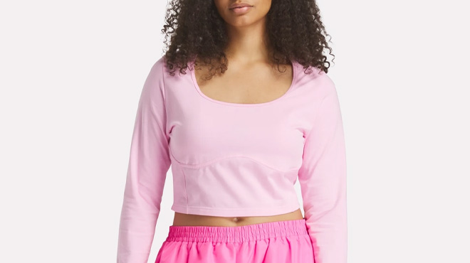 A Woman Wearing Reebok x Barbie Crop Top