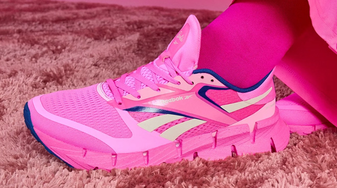 A Woman Wearing Reebok x Barbie FloatZig 1 Running Shoes